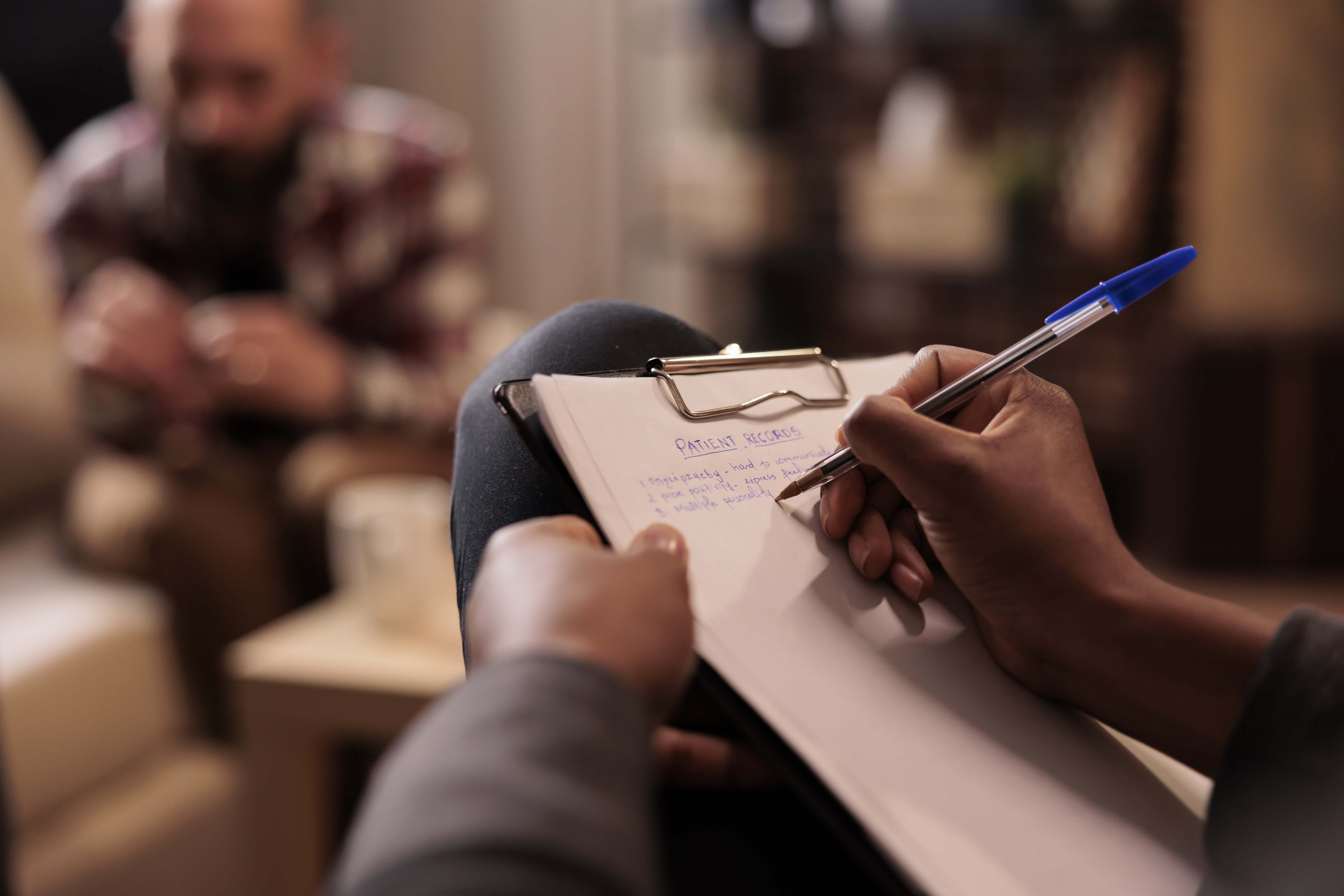 male-psychologist-taking-notes-couple-therapy-session-help-with-relationship-issues-counselor-giving-advice-explaining-marriage-problems-using-paper-psychoanalysis-close-up.jpg